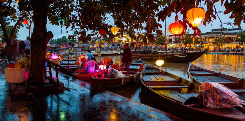 Hoi An, Vietnam. Street view with traditional boats on a background of ancient town